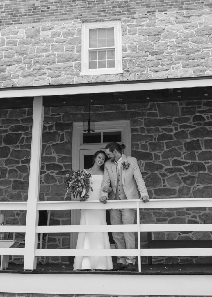 Black and white wedding portrait on the farmhouse porch at The Homestead Farm
