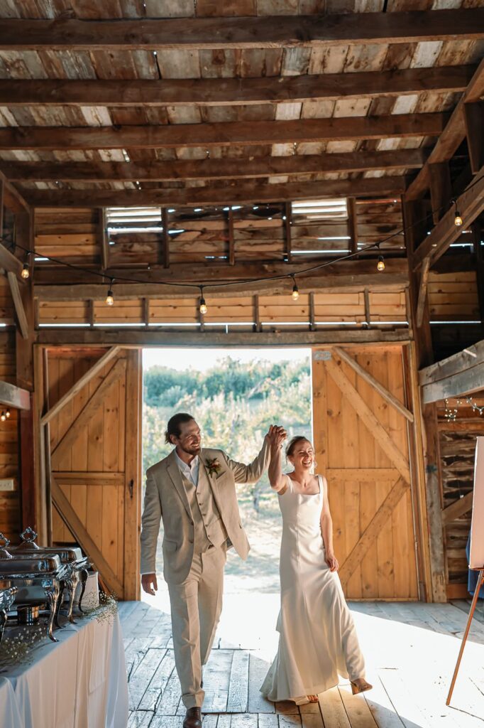 Bride and groom entering their wedding reception at The Homestead Farm Historic Wright-Barton Venue