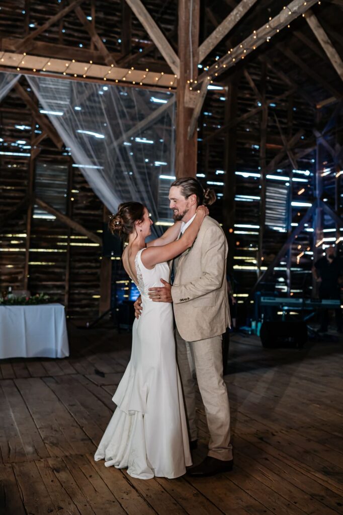 First dance inside the historic barn at The Homestead Farm wedding venue