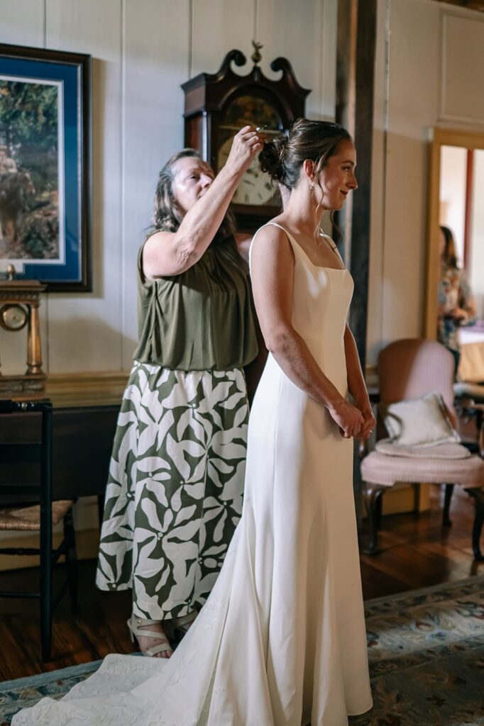 Bride applying makeup during wedding morning at The Homestead Farm